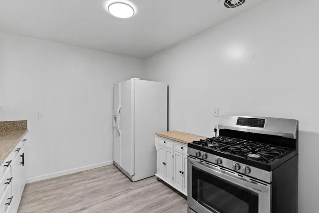 a stove top oven sitting inside of a kitchen