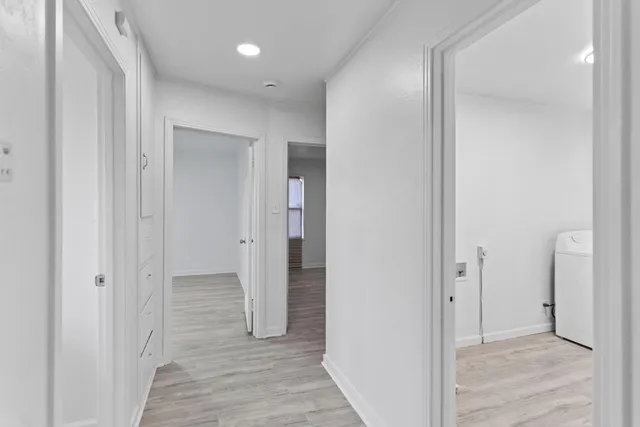 a view of a hallway with wooden floor