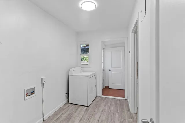 a view of a room with wooden floor