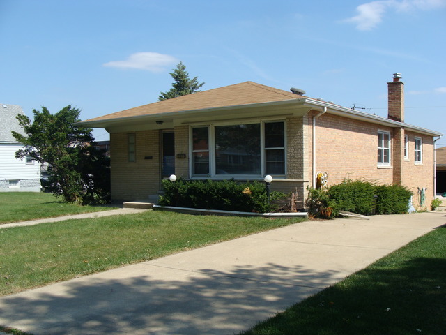 10819 Menard Avenue Chicago Ridge, IL 60415 - Photo 1 of 8 a front view of a house with garden
