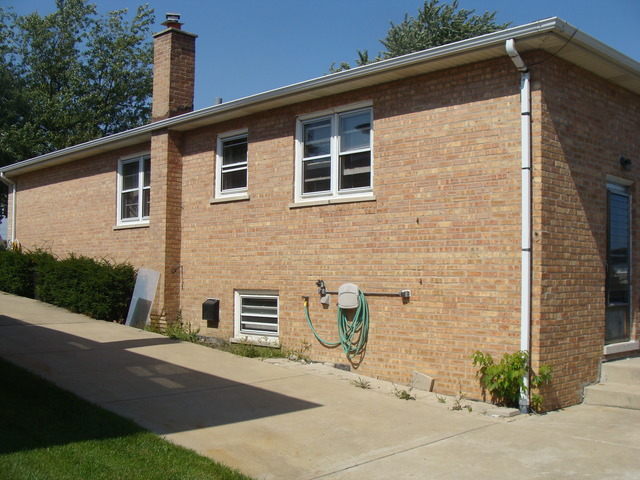 10819 Menard Avenue Chicago Ridge, IL 60415 - Photo 2 of 8 a front view of a house with a yard