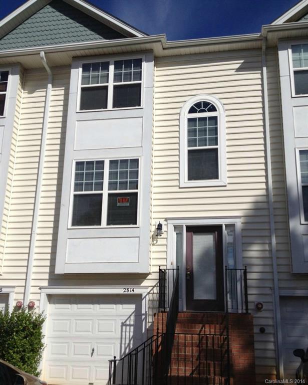 a view of a house with more windows and brick walls