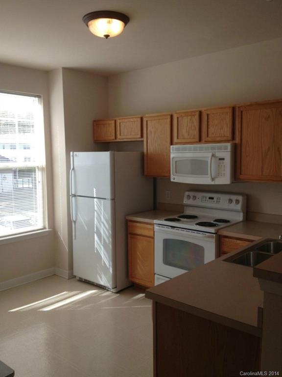 2814 Avalon Loop Road, Unit 2814 Charlotte, NC 28269 - Photo 3 of 7 a kitchen with a refrigerator sink and stove