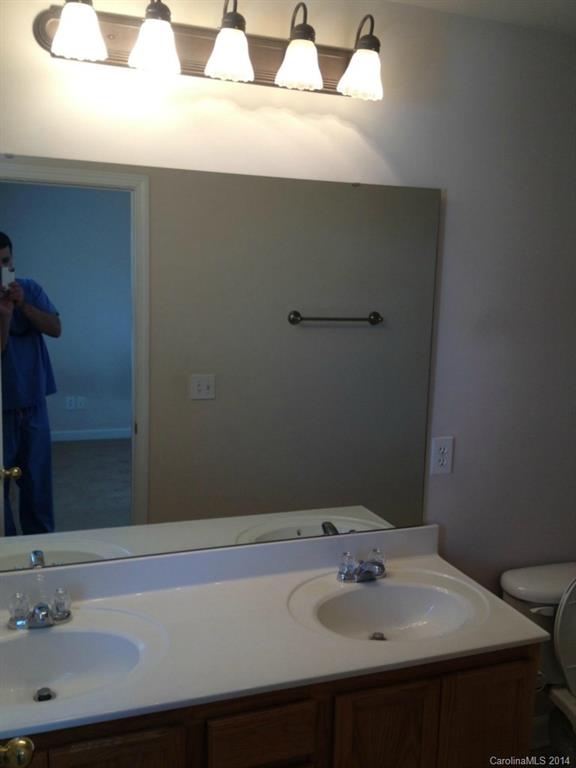 2814 Avalon Loop Road, Unit 2814 Charlotte, NC 28269 - Photo 6 of 7 a bathroom with a sink and a mirror