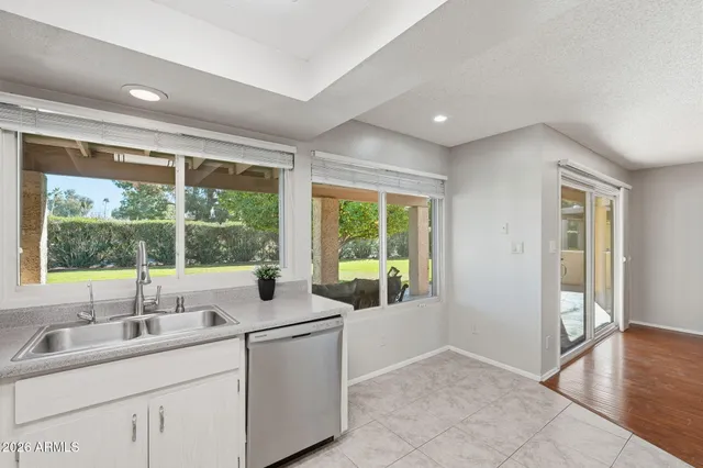 a kitchen with white cabinets appliances and sink