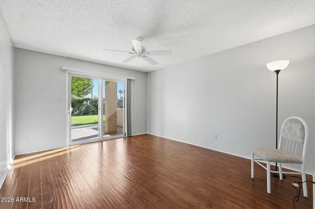 a view of empty room with wooden floor and outdoor view