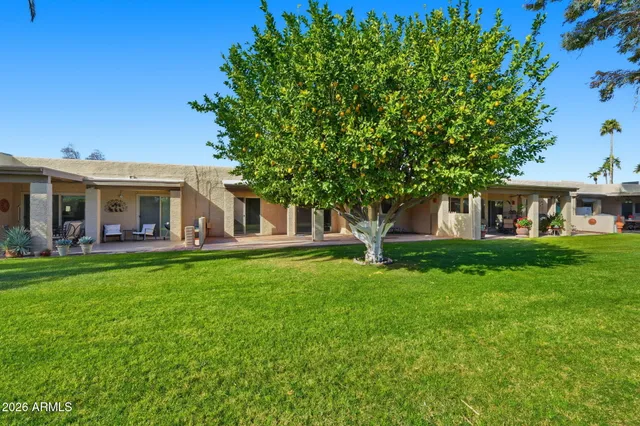 a front view of a house with a garden