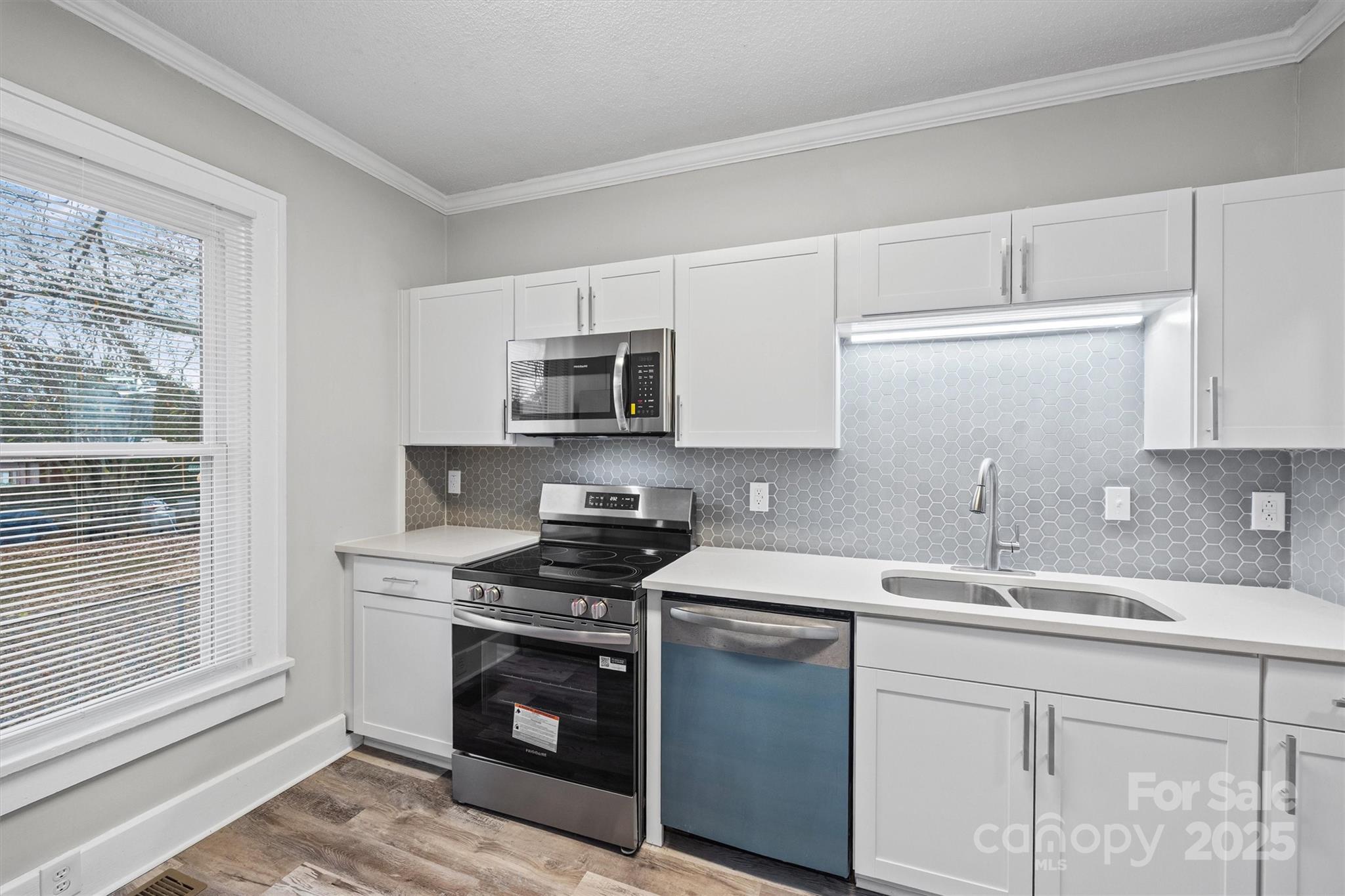 548 Flint Street Rock Hill, SC 29730 - Photo 11 of 28 a kitchen with sink a microwave and cabinets