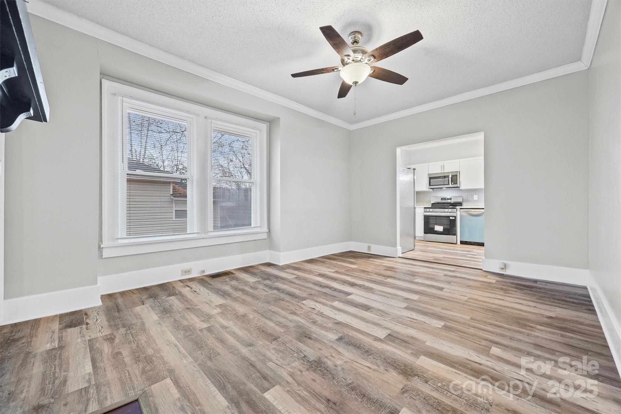 548 Flint Street Rock Hill, SC 29730 - Photo 10 of 28 a view of an empty room with a window and a kitchen
