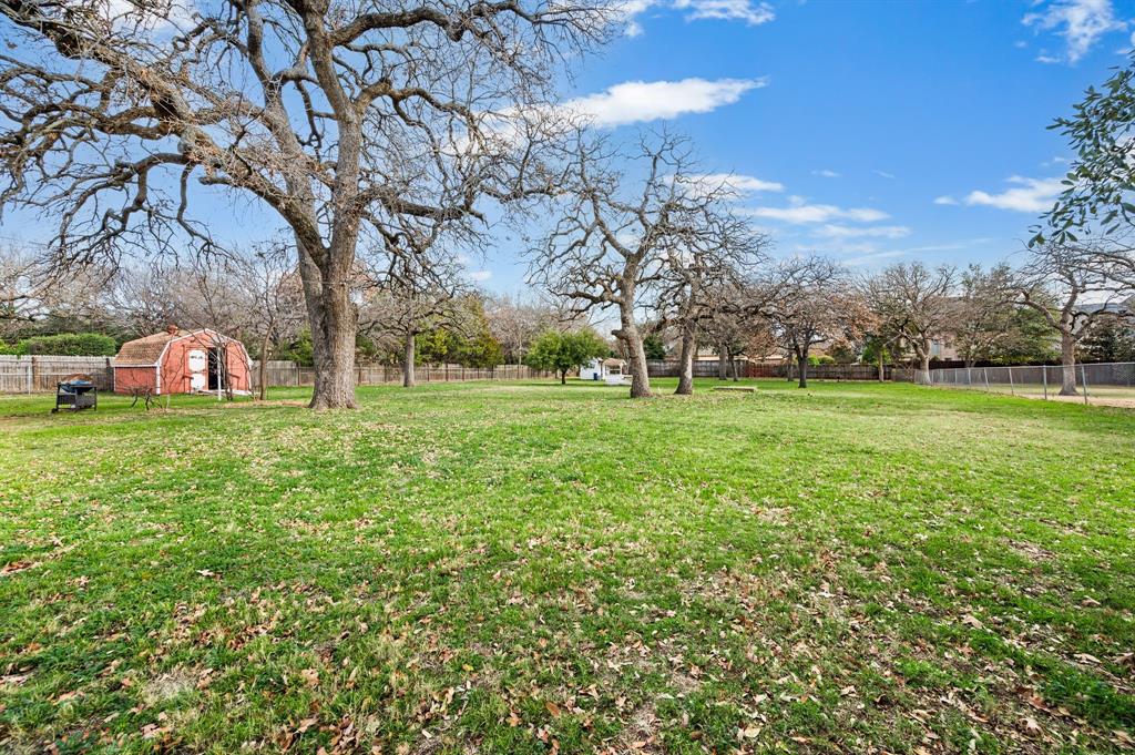 6701 Herbert Road Colleyville, TX 76034 - Photo 12 of 22 a view of a field with large trees