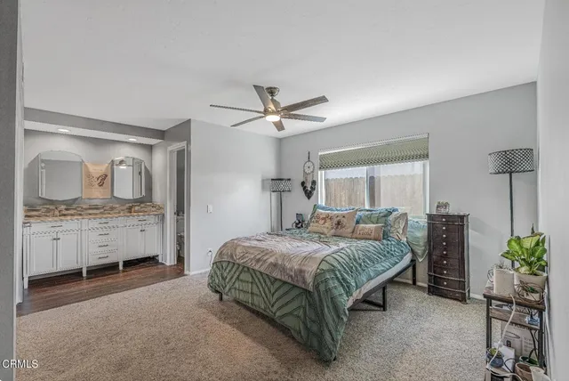 a bathroom with a double vanity sink toilet mirror and bathtub