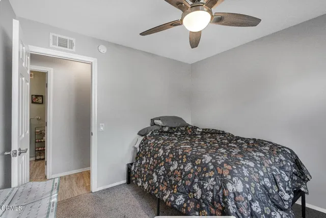 a living room with furniture and paintings on the wall