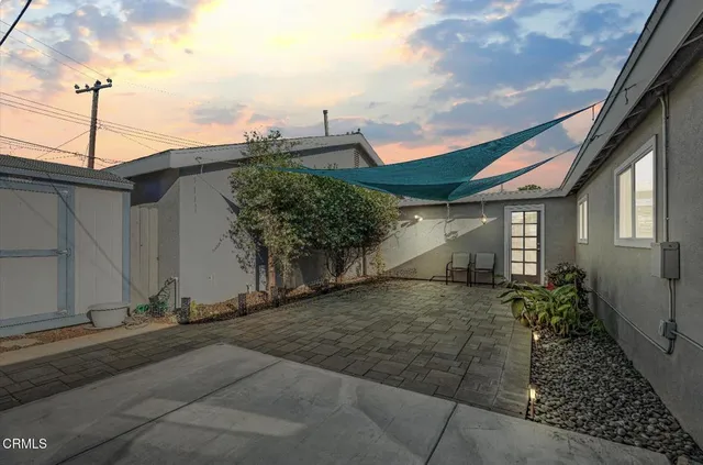 a front view of a house with outdoor seating