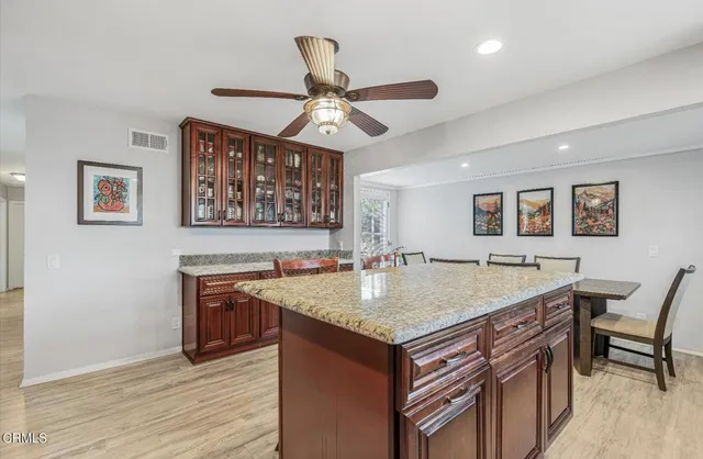 a kitchen with a sink a counter space and cabinets
