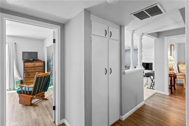 a view of a hallway and a livingroom with furniture