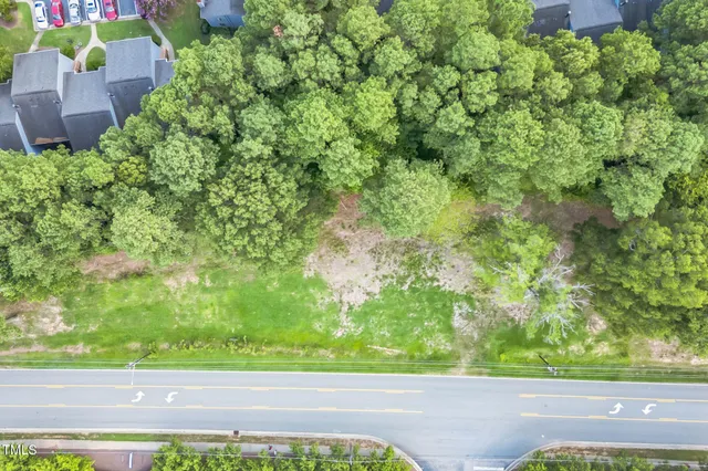 an aerial view of a house with a yard and garden