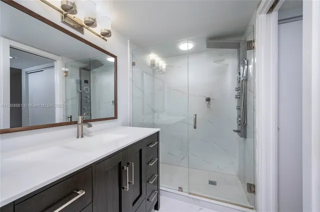 a bathroom with a shower sink and mirror