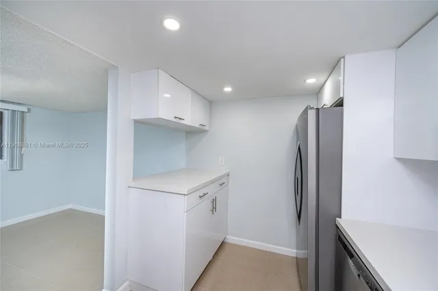 a view of hallway with cabinets