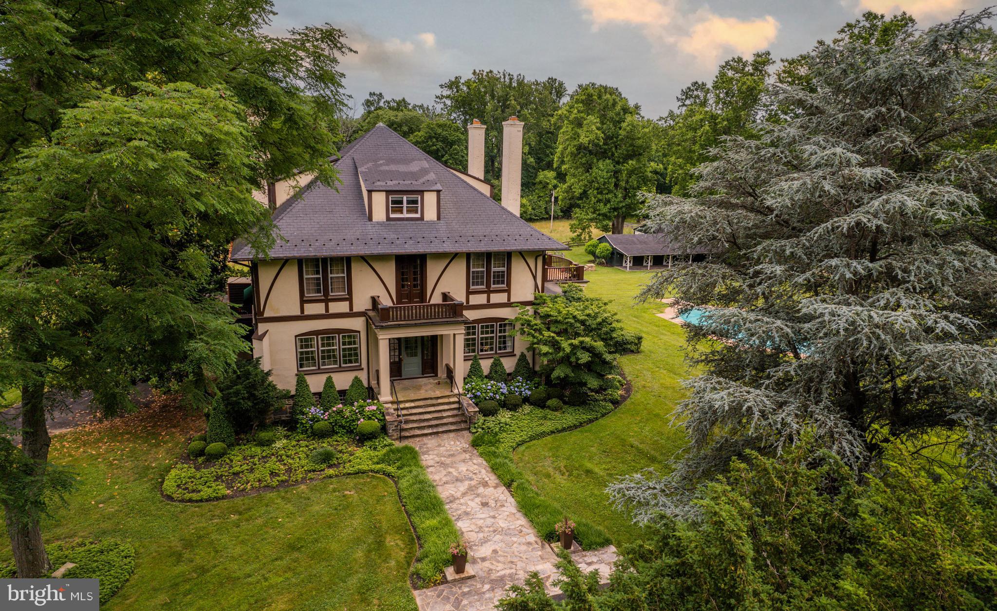a aerial view of a house with yard and green space