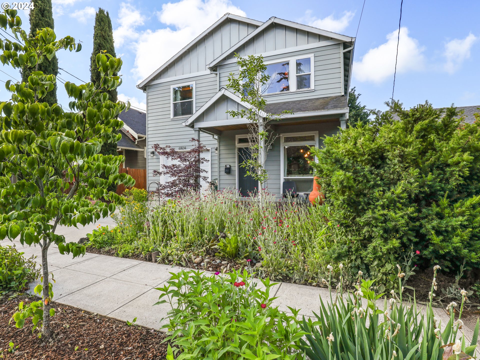 6924 Southeast Boise Street Portland, OR 97206 - Photo 23 of 45 a view of a house with potted plants and a flower plants
