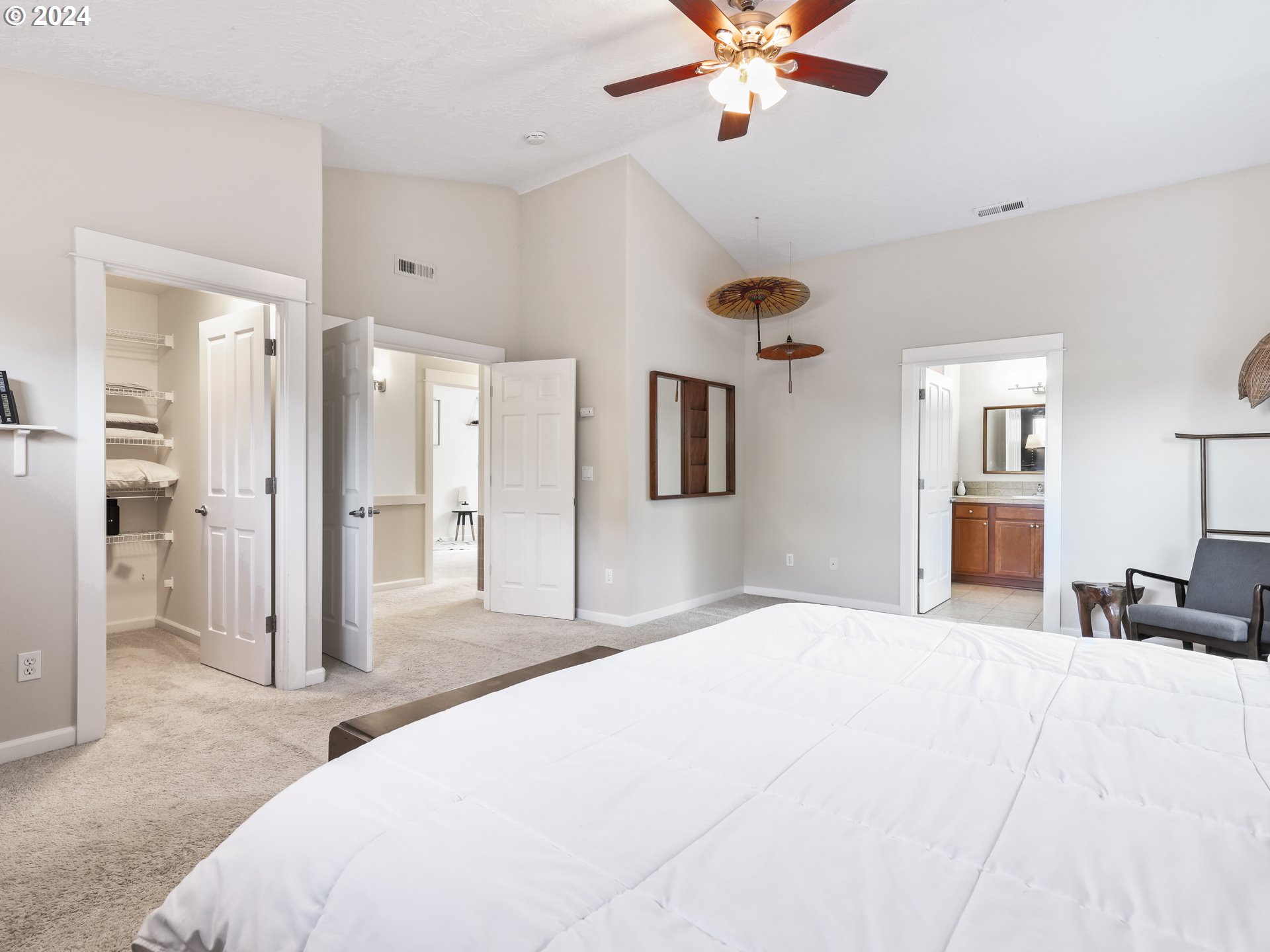 6924 Southeast Boise Street Portland, OR 97206 - Photo 28 of 45 a spacious bedroom with a bed and a chandelier