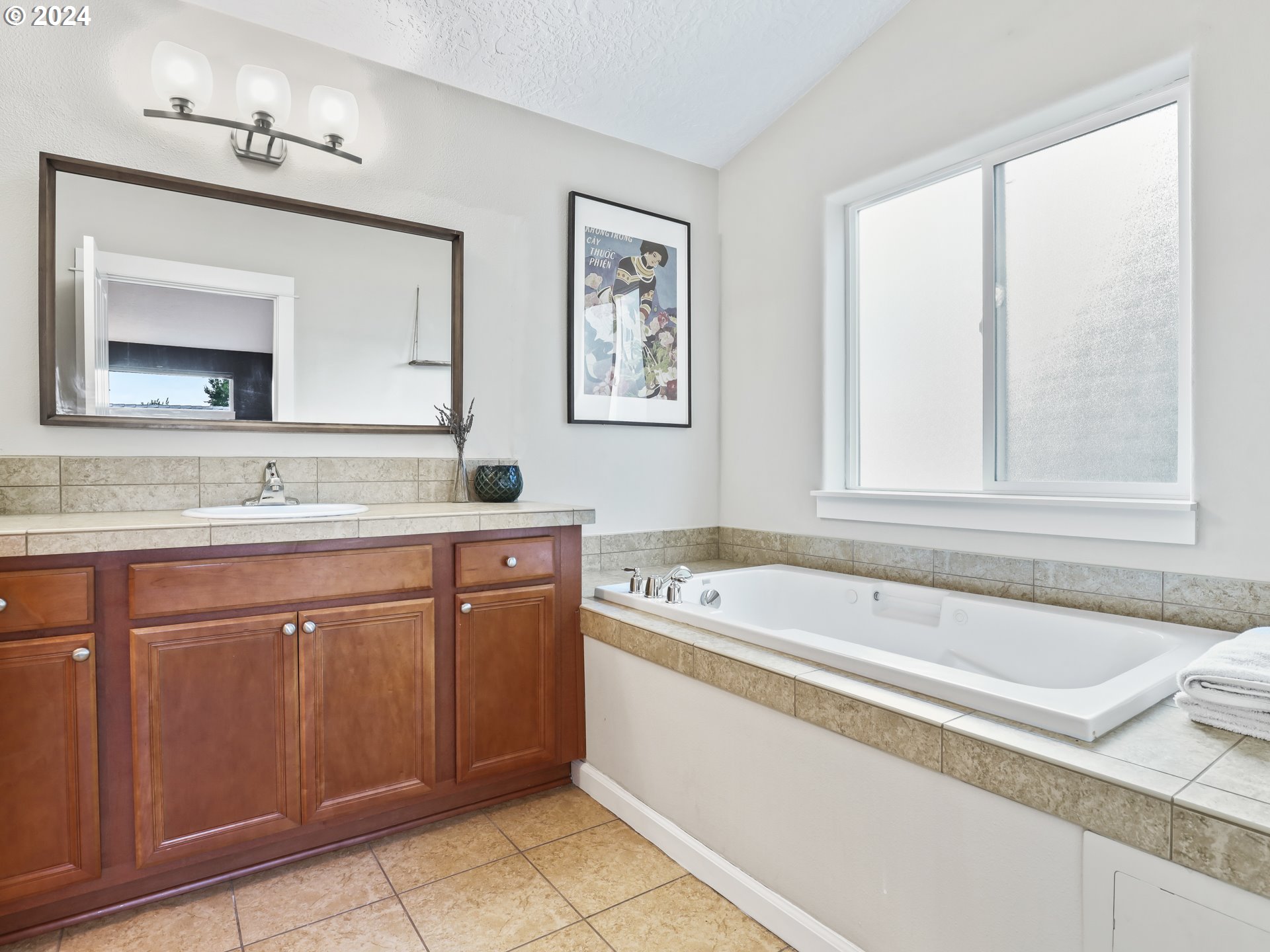 6924 Southeast Boise Street Portland, OR 97206 - Photo 29 of 45 a bathroom with a granite countertop tub sink and mirror