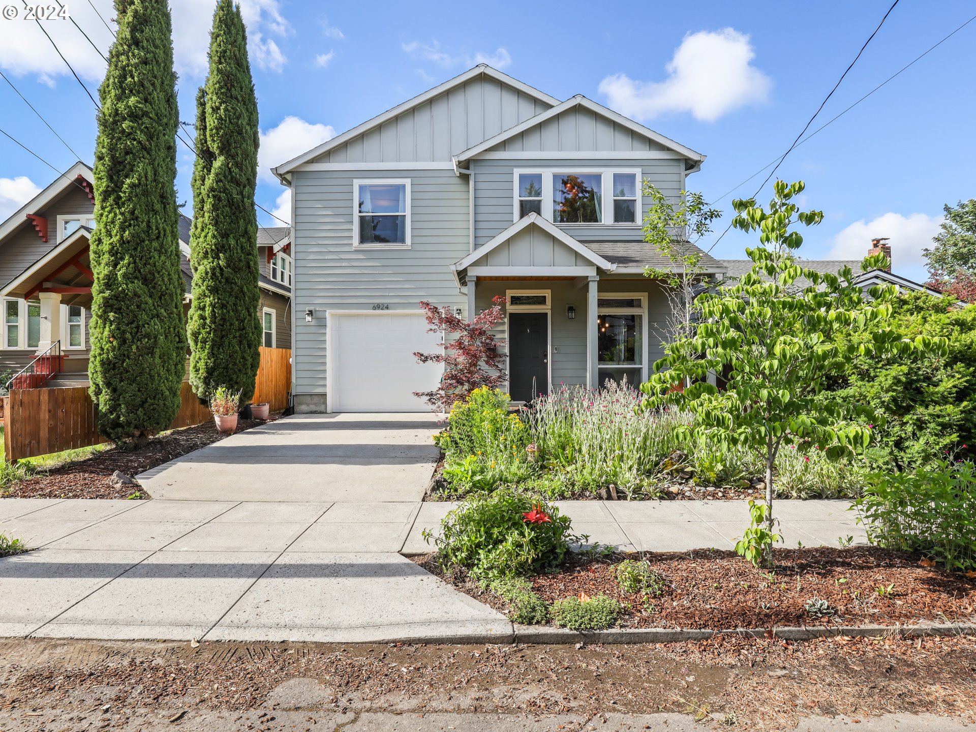 6924 Southeast Boise Street Portland, OR 97206 - Photo 34 of 45 a front view of a house with a yard