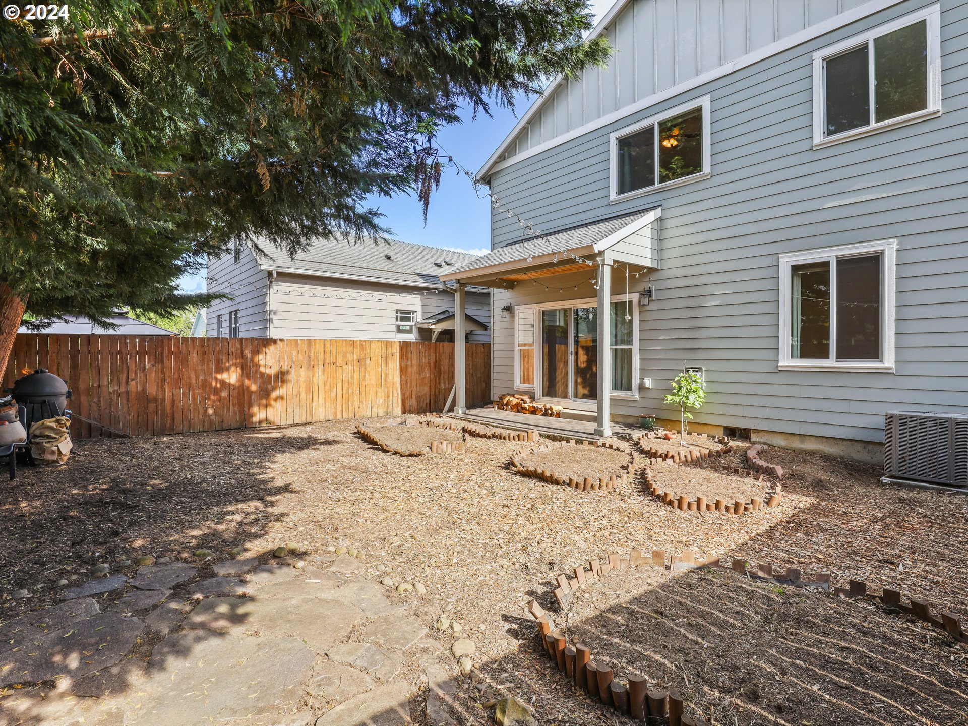 6924 Southeast Boise Street Portland, OR 97206 - Photo 39 of 45 a view of a backyard with a large tree