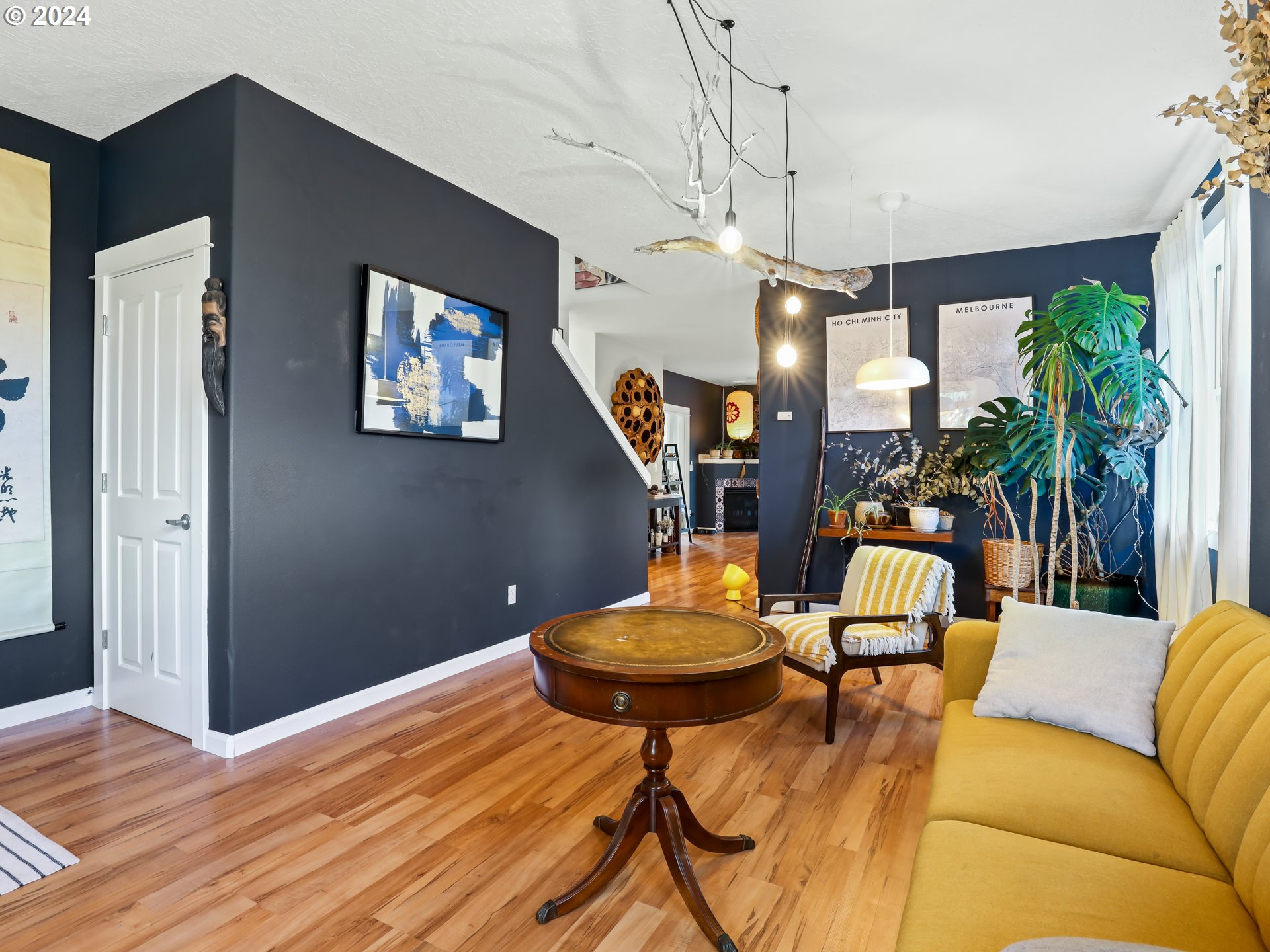 6924 Southeast Boise Street Portland, OR 97206 - Photo 6 of 45 a living room with furniture a chandelier and a wooden floor