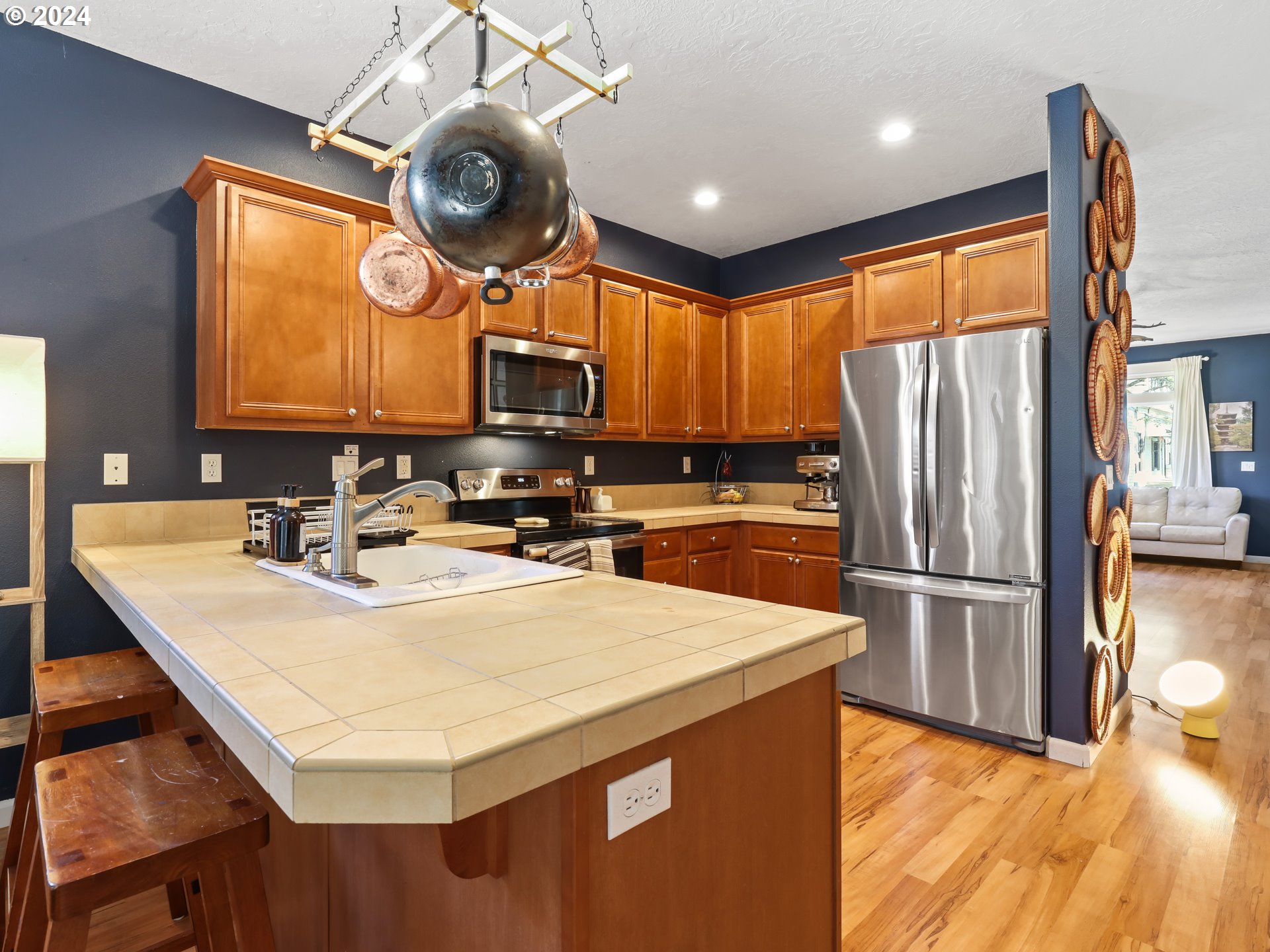 6924 Southeast Boise Street Portland, OR 97206 - Photo 10 of 45 a kitchen with stainless steel appliances granite countertop a sink a stove and a refrigerator
