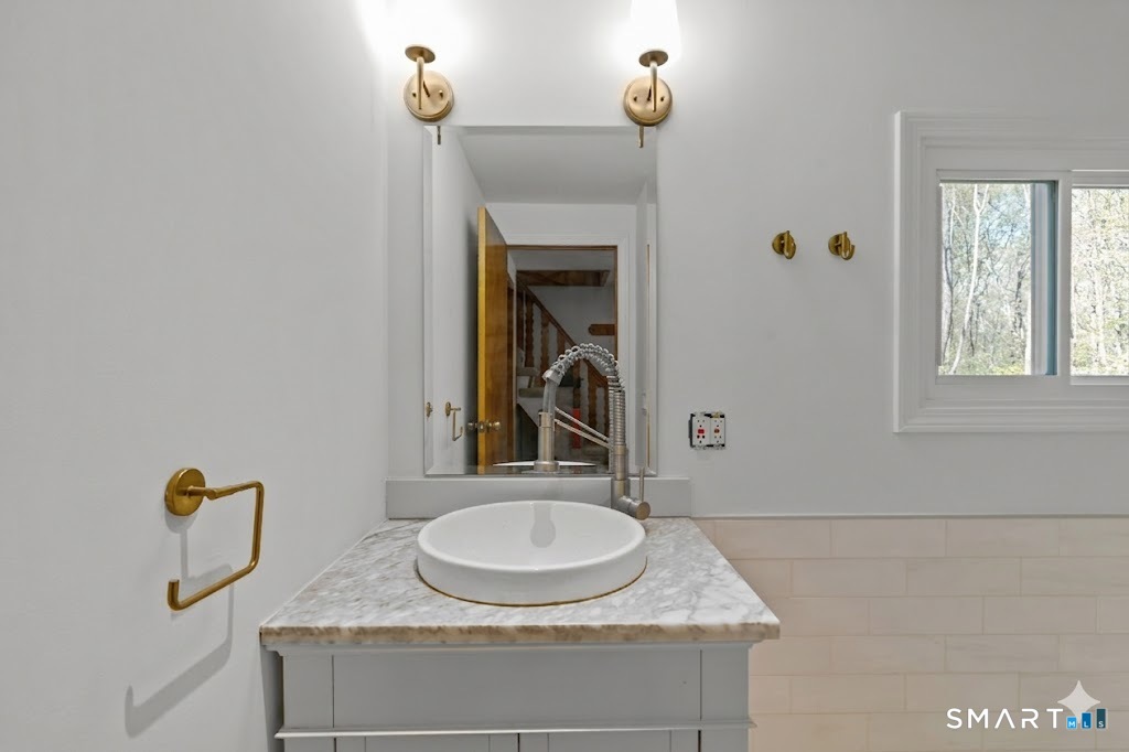 343 Hope Furnace Road Hope, RI 02831 - Photo 2 of 35 a bathroom with a granite countertop sink and a mirror