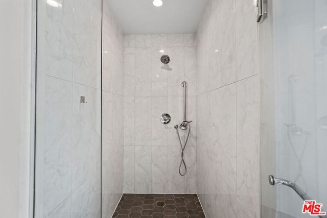 a bathroom with a glass shower door