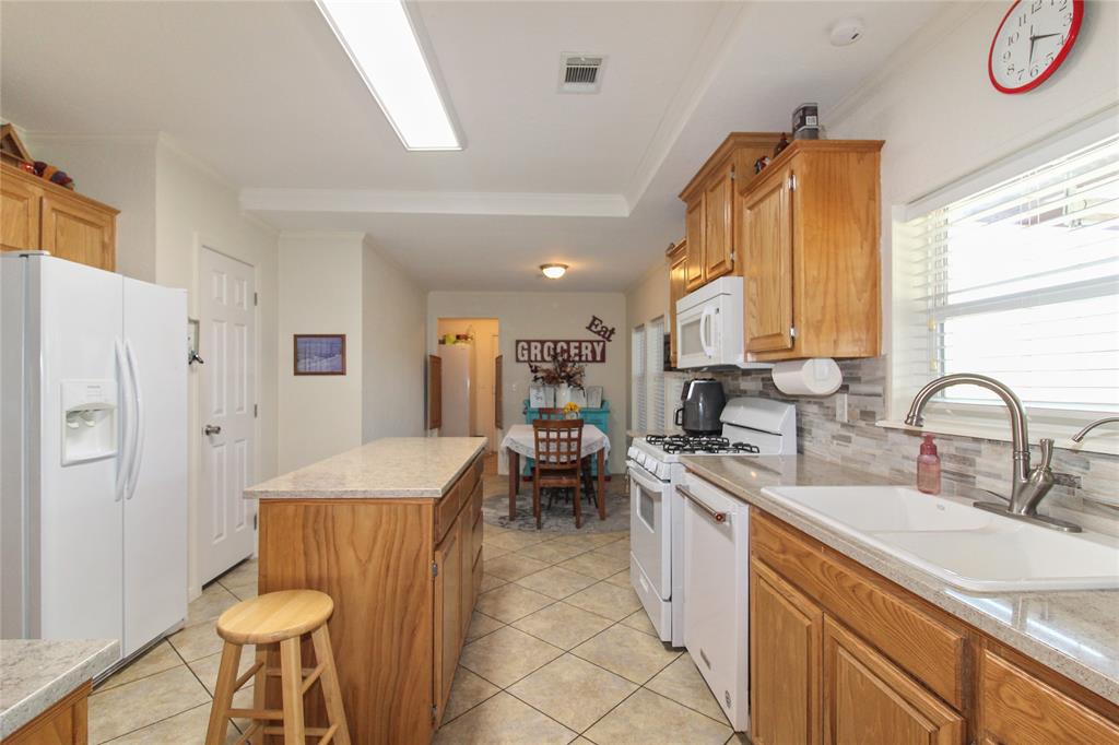 455 Hughes Cemetery Road Italy, TX 76651 - Photo 14 of 40 a kitchen with stainless steel appliances granite countertop a sink a stove and a refrigerator