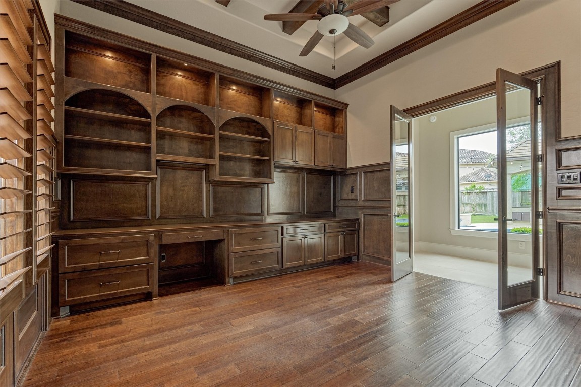 25 Post Shadow Estate Drive Spring, TX 77389 - Photo 29 of 50 Elegant home office with custom built-ins, rich wood floors, and airy ceiling details for focused workdays.