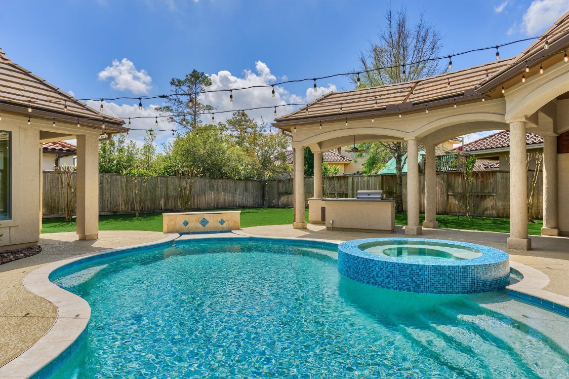 25 Post Shadow Estate Drive Spring, TX 77389 - Photo 45 of 50 Resort-style backyard featuring a sparkling pool and raised spa, surrounded by expansive patio space.