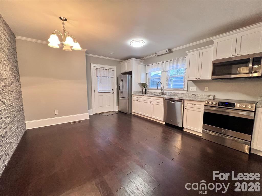 2104 Moose Road Kannapolis, NC 28083 - Photo 7 of 20 a kitchen with stainless steel appliances granite countertop a stove a sink dishwasher and a refrigerator with wooden floor
