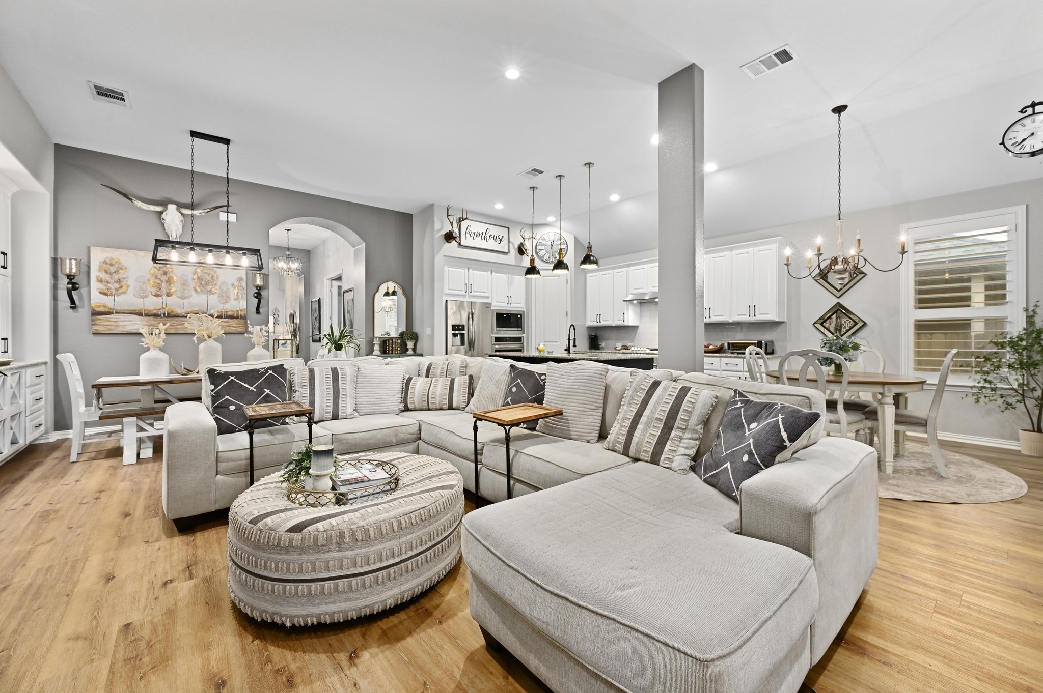169 Fort Cobb Way Georgetown, TX 78628 - Photo 11 of 28 a living room with furniture kitchen view and a chandelier