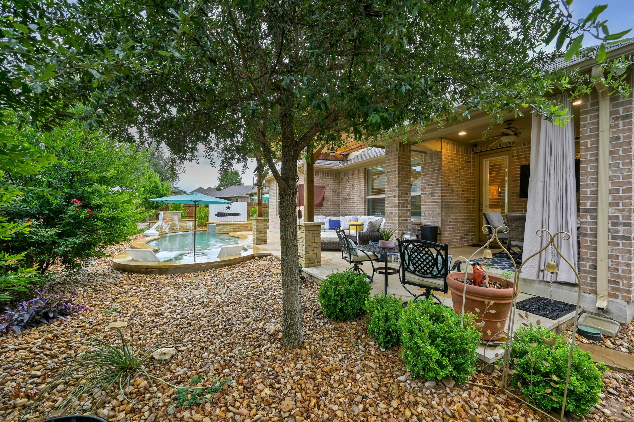 169 Fort Cobb Way Georgetown, TX 78628 - Photo 28 of 28 a view of a patio with table and chairs potted plants and large tree