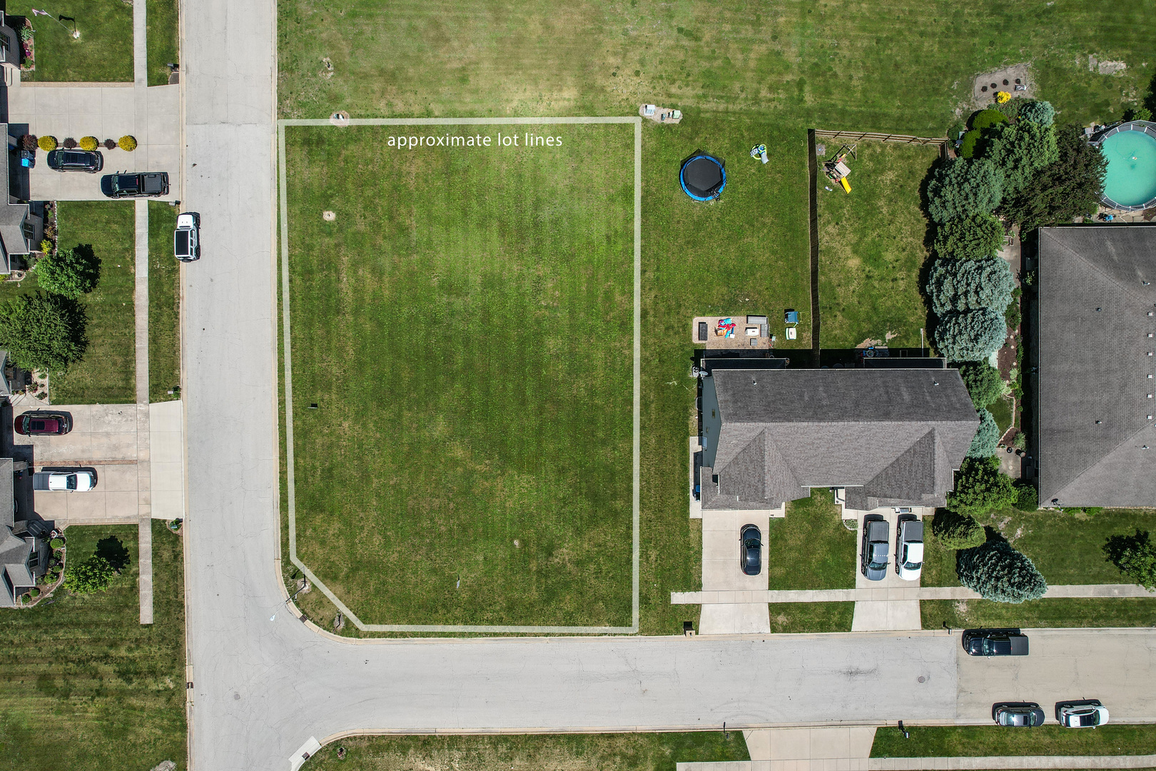 an aerial view of a residential houses with yard