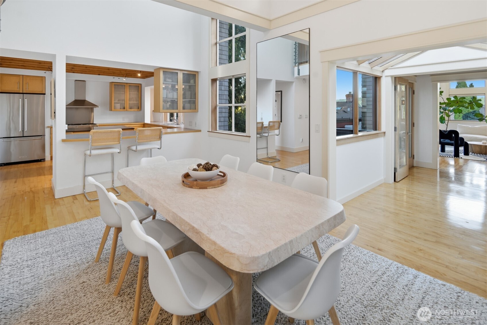 8770 Sand Point Way Northeast Seattle, WA 98115 - Photo 11 of 40 a view of a dining room with furniture and wooden floor