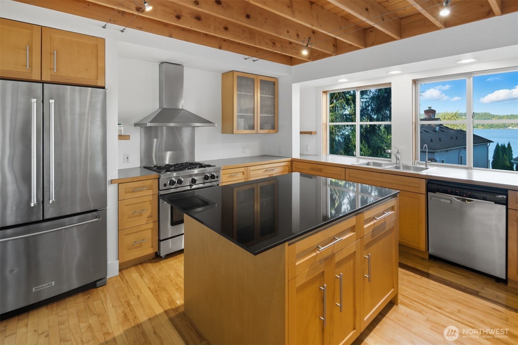 8770 Sand Point Way Northeast Seattle, WA 98115 - Photo 13 of 40 a kitchen that has a sink a stove and a refrigerator