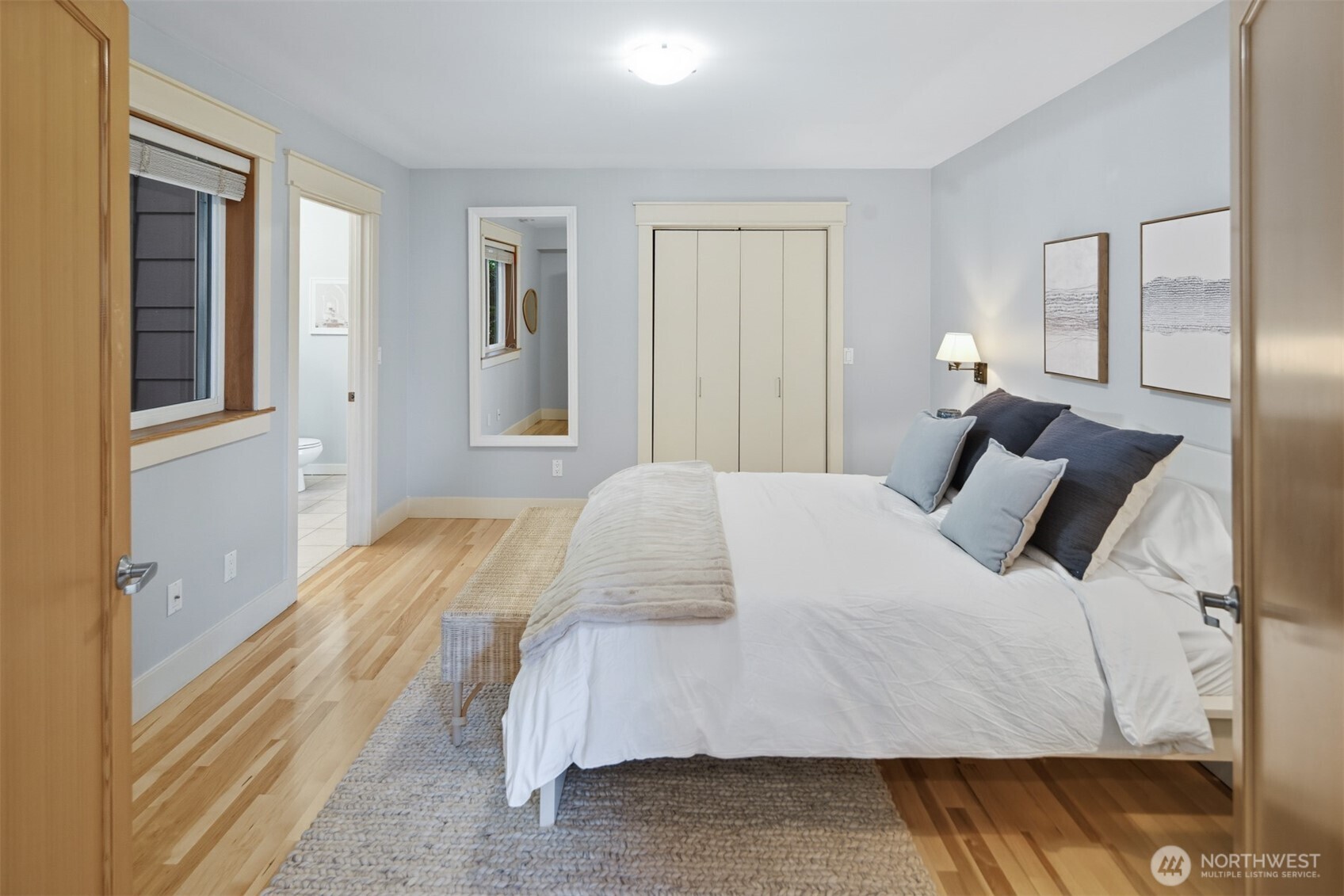 8770 Sand Point Way Northeast Seattle, WA 98115 - Photo 24 of 40 a bedroom with a bed and wooden floor