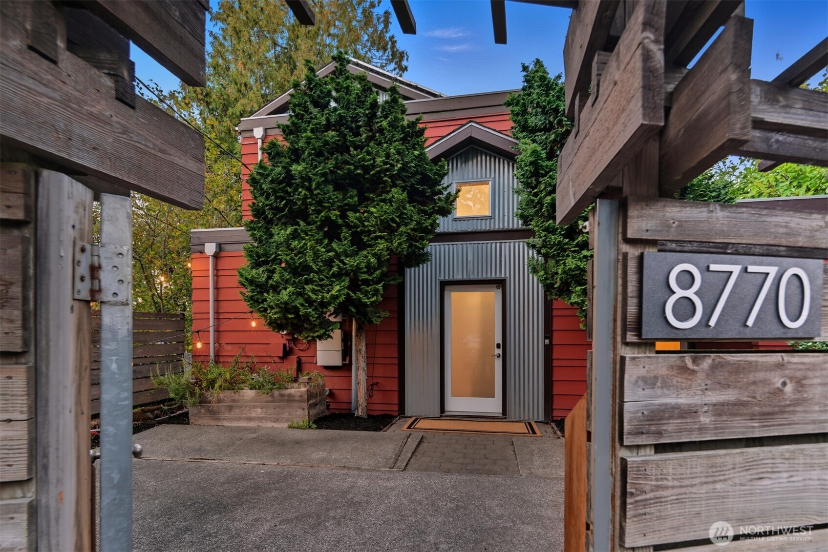 8770 Sand Point Way Northeast Seattle, WA 98115 - Photo 36 of 40 a view of a street with brick wall and potted plants