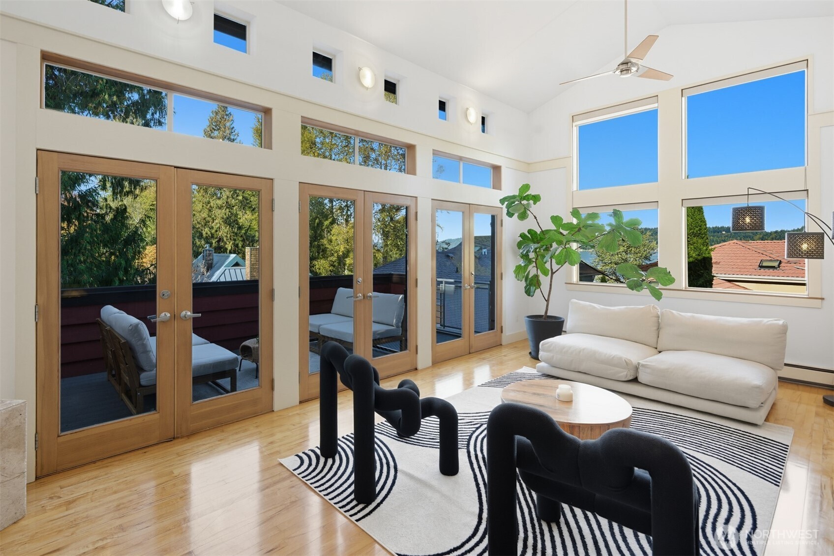 8770 Sand Point Way Northeast Seattle, WA 98115 - Photo 6 of 40 a living room with furniture and a floor to ceiling window