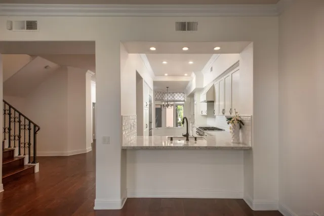 a kitchen with granite countertop a stove and a refrigerator