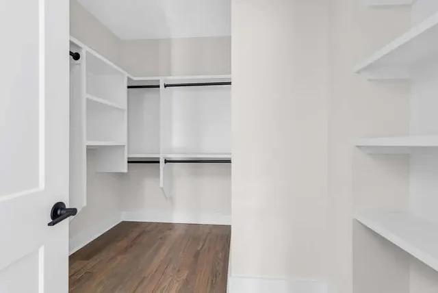 a view of walk in closet with empty racks