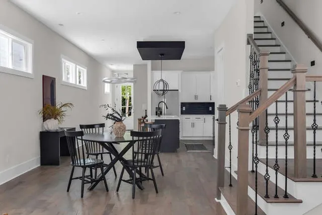 a view of a dining room with furniture and wooden floor