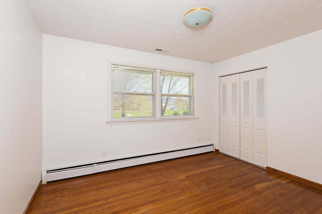 3760 Rockfish Road Grottoes, VA 24441 - Photo 14 of 34 an empty room with wooden floor and windows