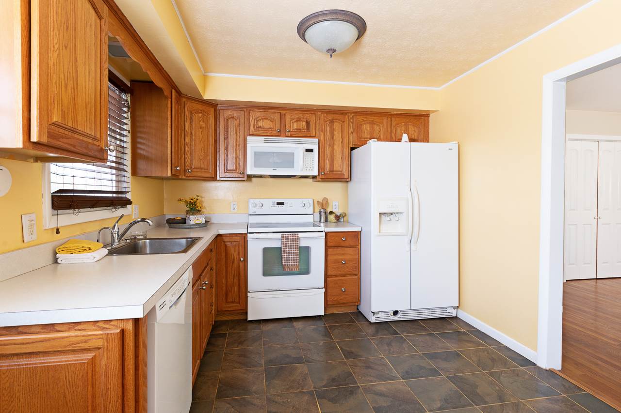3760 Rockfish Road Grottoes, VA 24441 - Photo 5 of 34 a kitchen with a white stove top oven and refrigerator