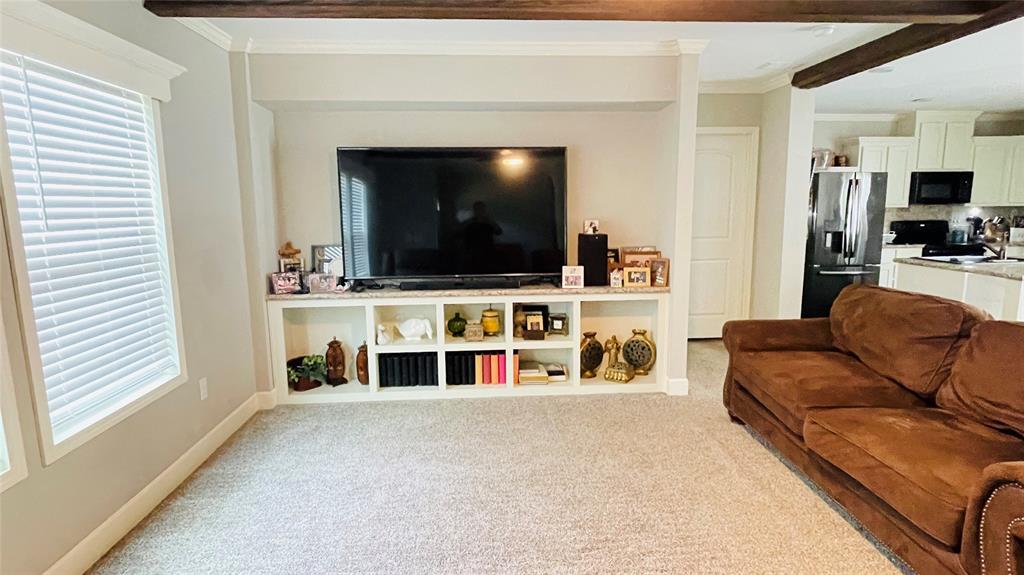 8394 Lake Road Mansfield, TX 76063 - Photo 11 of 22 a living room with furniture and a flat screen tv